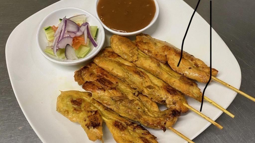 Satay Chicken · Chicken on skewers, grilled and served with peanut sauce and cucumber salad.