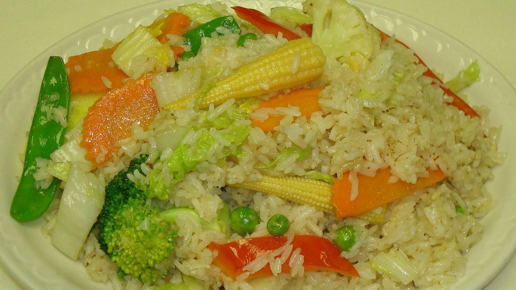 Vegetable Fried Rice · Jasmine rice accompanied with garlic, cabbage, peas, carrots, broccoli, and tomatoes.