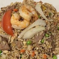Combination Fried Rice · Fried rice with shrimp, beef, chicken, scrambled egg, tomatoes, onions, peas, carrots, and c...