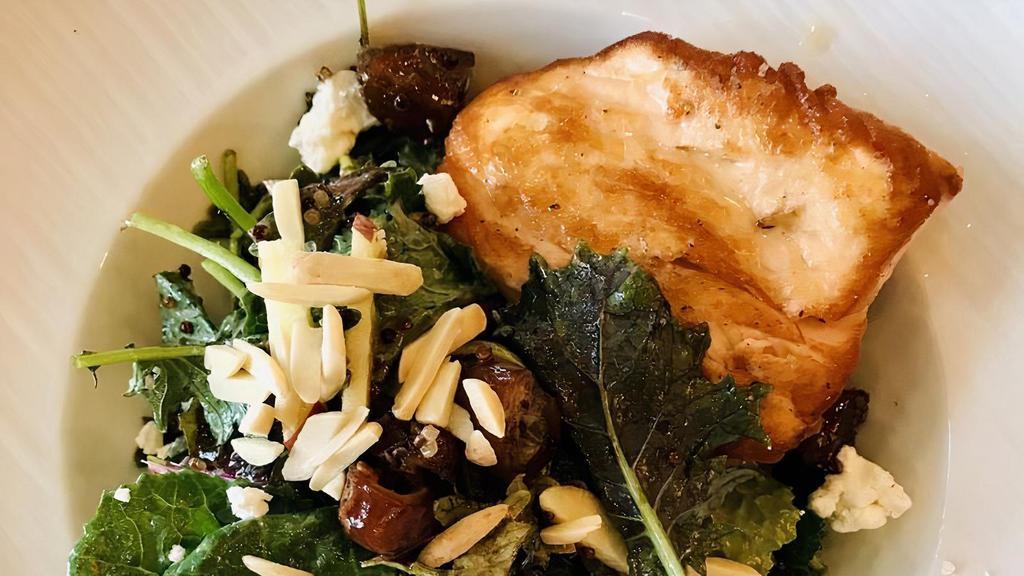 Seared Salmon Baby Kale Salad · Rainbow quinoa, Fuji apples, dates, goat cheese crumbles, slivered almonds and honey champagne vinaigrette