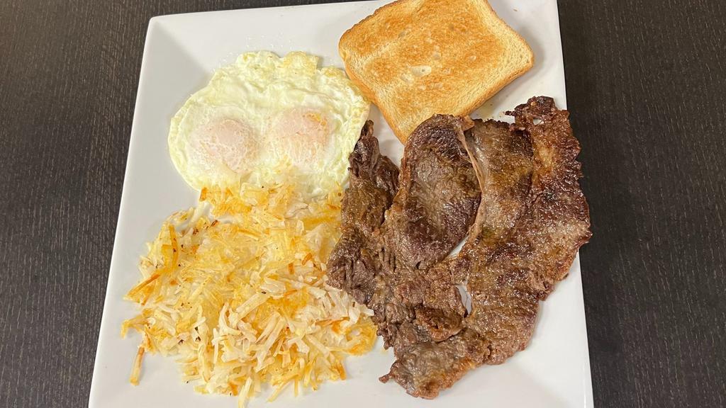 Steak And Eggs · 2 eggs over medium, Carne Asada, shredded hash brown and white toast.