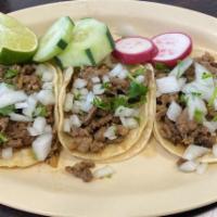 Tacos · Corn tortilla taco with choice of meat topped with onion and cilantro