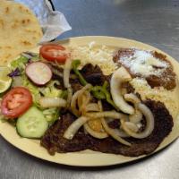 Carne Asada · Steak served with rice, beans, salad and tortillas