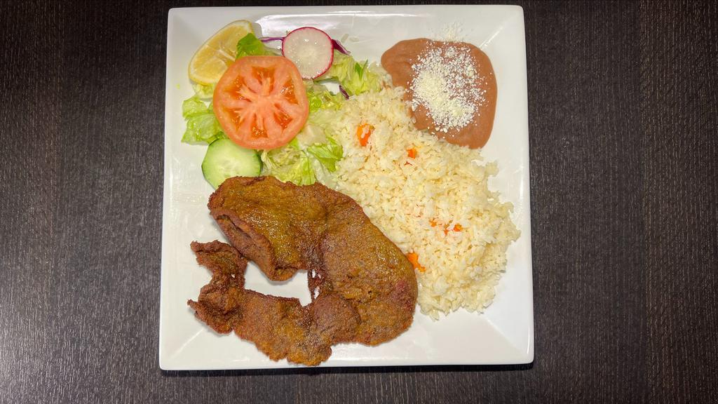 Plato De Milanesa · Breaded steak served with rice, beans,salad,and tortillas.