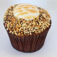 Chocolate Caramel Drum · Vanilla bean cake frosted with fudge dipped in peanuts and topped with vanilla bean buttercr...