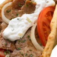 Gyro Sand. · Slices of gyro meat, tomato and red onion on pita bread. Gyro sauce on the side.