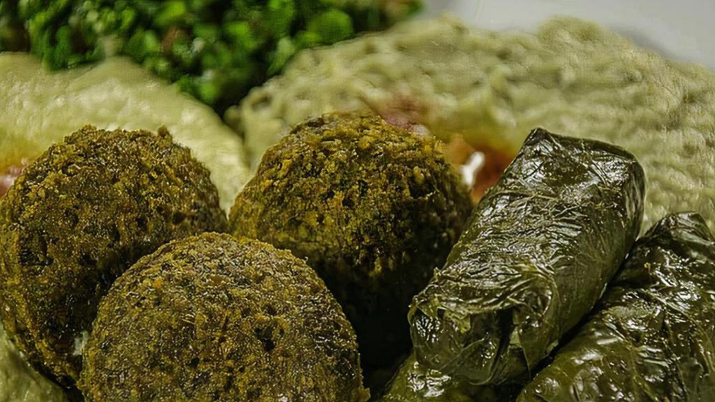 Vegetarian Platter · Homemade hummus, Baba ghanouj, tabouli, falafel and hand rolled grape leaves.