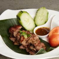 Crying Tiger · Medium spicy. Sliced marinated tender flank steak with manaao dipping sauce.