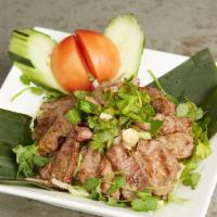 Yum Nua · Hot. Sliced grilled beef steak tossed with onions, tomato, cucumber, roasted rice powder wit...