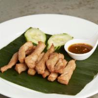 Moo Dad Deaw · Deep-fried sun-drying seasoned strips of pork and served with spicy lime sauce.
