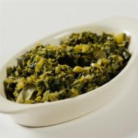 Collard Greens · Steamed and delicately seasoned with garlic and green chilies. Served with Injera