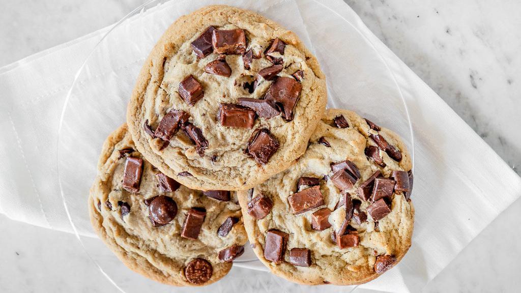 Decadant Triple Chocolate Chip Cookies · Freshly baked chocolate chip cookies topped with lot's of milk and dark chocolate chunks, and Hershey's kisses.