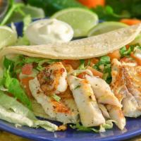Grilled Fish Soft Taco · Served on two corn tortillas, lettuce, pico de gallo and homemade white cream sauce.