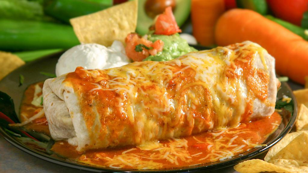 El Grande Burrito · Filled with chunks of beef, chicken, or pork, beans, sour cream, fresh guacamole, topped with ranchera salsa, cheese.