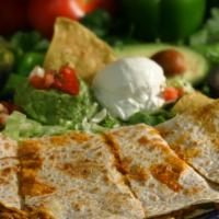 Shredded Beef, Chicken Or Shrimp Quesadilla · Flour tortilla filled with cheese and grilled to perfection. Served with fresh guacamole and...