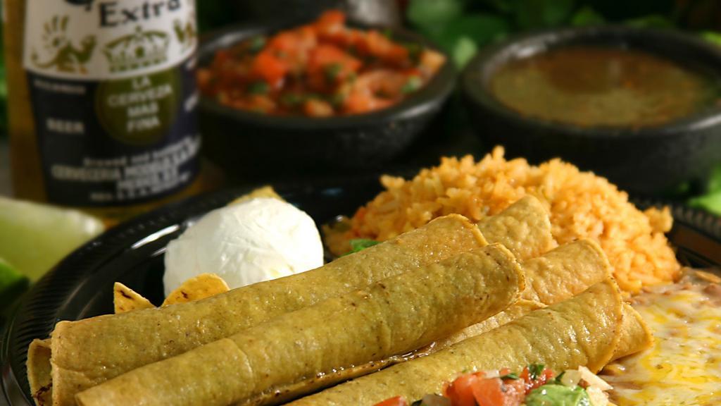 Two Taquitos · Crispy hand-rolled corn tortillas, filled with shredded beef or chicken and topped with guacamole.