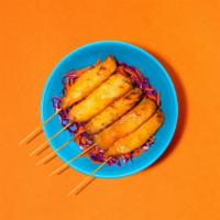 Spicy Chicken Satay · Three chicken satay skewers served with spicy dipping sauce.