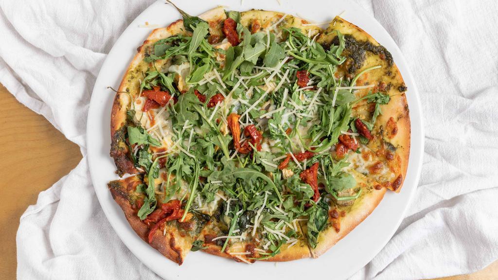 Napa Pizza · Baby artichokes, sun dried tomato, baby spinach, buffalo mozzarella, walnut pesto, parmesan cheese, garnished with arugula, pepper oil.