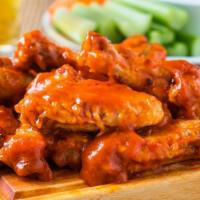 The Buffalo Hot Wings · Crispy chicken wings fried and tossed in spicy buffalo sauce.