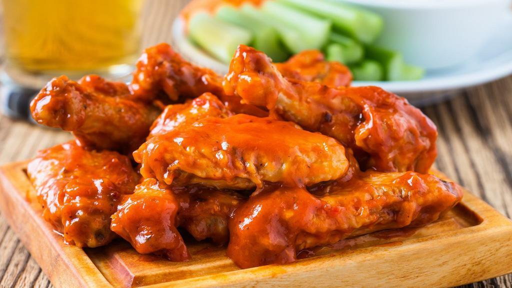 The Buffalo Wings · Special spicy buffalo sauce tossed on wings with customer's choice of bone-in or boneless! Served with choice of ranch, bleu cheese, BBQ, honey mustard or sweet & sour side sauce!
