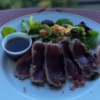 Herb Seared Rare Ahi Tuna · Four (4) ounces of sliced rare Tuna served with pickled ginger, wasabi, ponzu, and baby mixe...