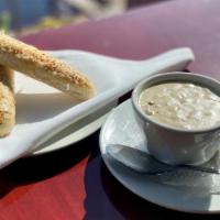 New England Clam Chowder · White cream-based clam chowder
**contains bacon