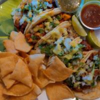 Soft Taco Plate · Your choice of three soft tacos topped with onion, cilantro and guacamole sauce.  Served wit...