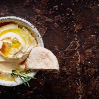 Hummus · Fresh house made hummus with chickpeas, tahini and side of pita bread.