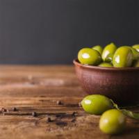 Green Olives · Fresh green olives in olive oil, topped with garlic and herbs.