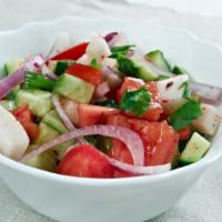 The Shirazi Salad (Mediterranean Style) · Fresh chopped cucumbers, tomatoes, onions, fresh lemon juice and olive oil dressing for exqu...