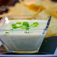 Cicada Cheese Dip · A delicious blend of three white cheeses, mild chiles, topped with green onion.