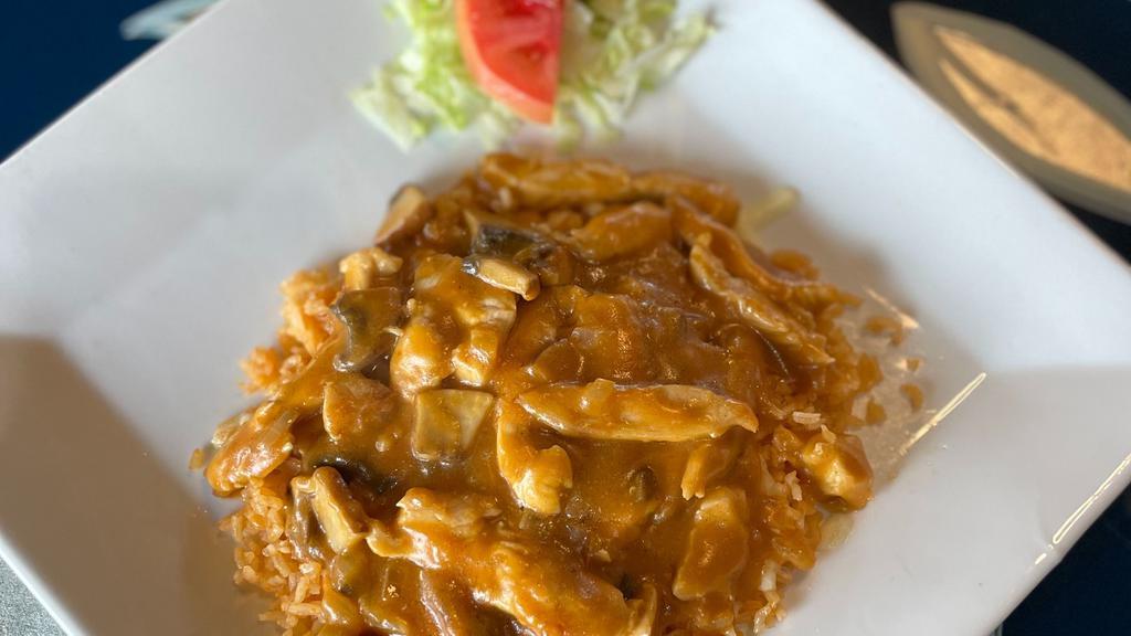 Arroz Con Pollo · Sautéed chicken breast, mushroom, onions in a rich tomato sauce. On a bed of red rice with melted Jack cheese. Served with red rice, refried beans and your choice of flour or corn tortillas.