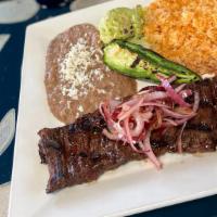 Arrachera · Marinated steak, garnished with grilled red onion, fried jalapeno and guacamole. Served with...