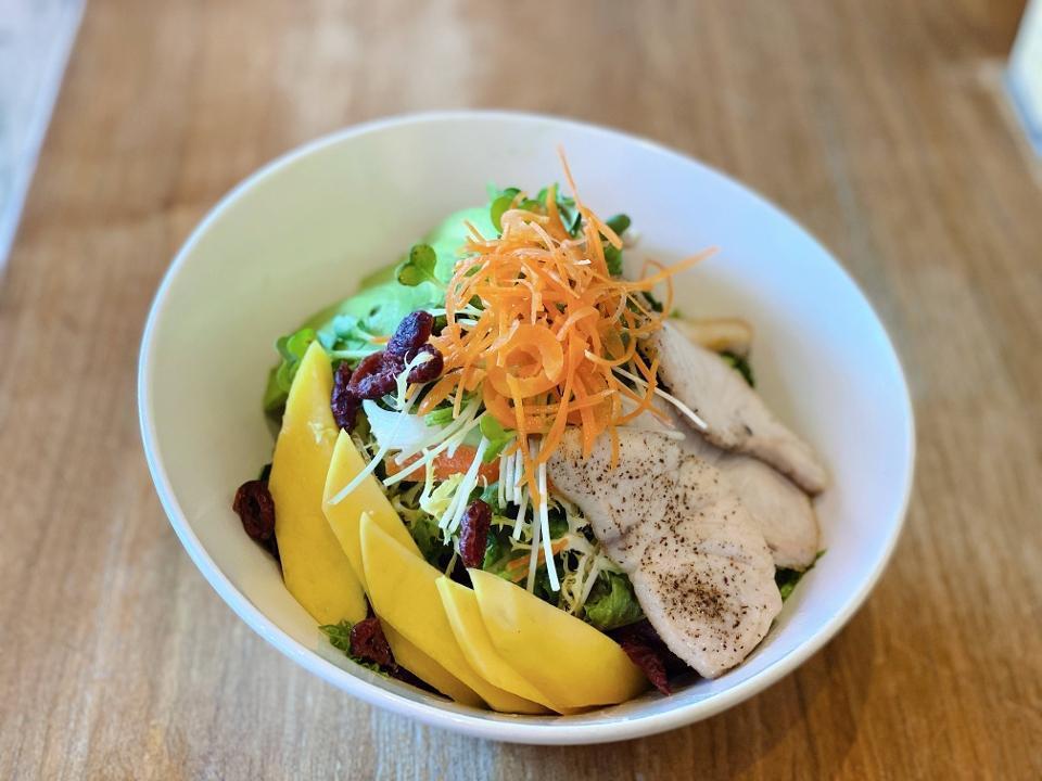 Hamachi Mango Salad · Seared Yellowtail, mango, avocado, kaiware.  sprouts, cucumber, carrots on a bed of organic greens, dried cranberries, apple-ginger dressing.