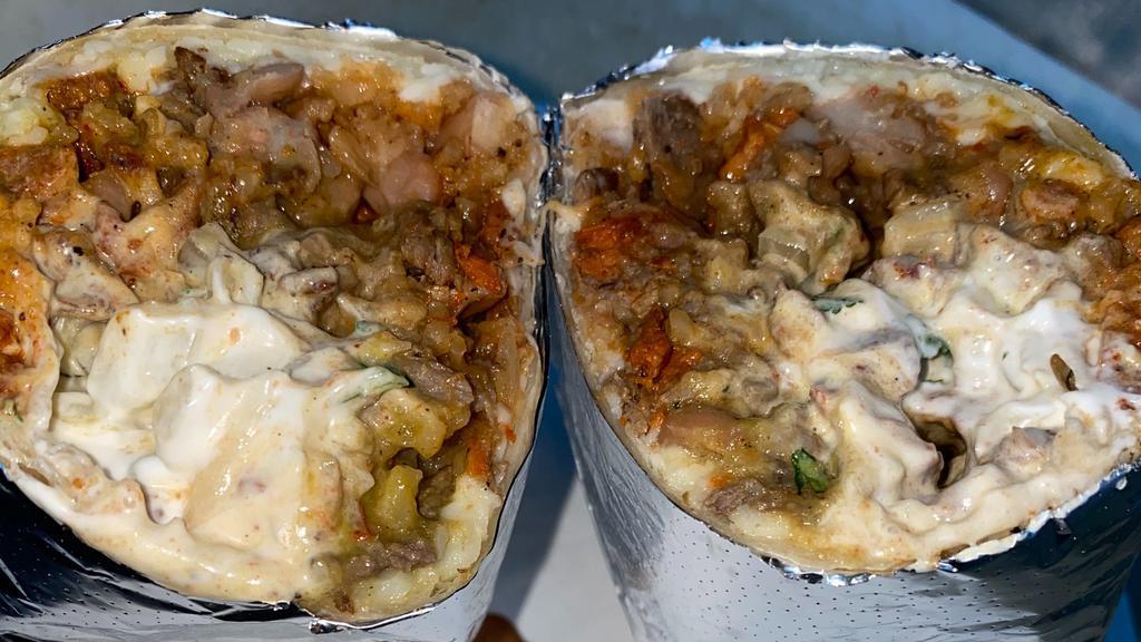 Super Burrito · Flour tortilla with your choice of meat, condiments, salsa, rice and beans as well as sour cream and cheese.
