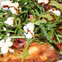 Fig & Prosciutto Flatbread · Wood-fired fig and prosciutto flatbread topped with arugula dressed in our brown sugar vinai...