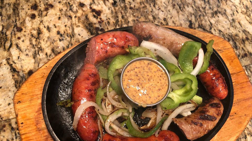 Sausage & Brat Trio · Hot andouille and mild Italian links are cooked in craft beer along with savory bratwurst, chargrilled and served sizzling with peppers, onions, and our spicy honey-mustard dijon.
