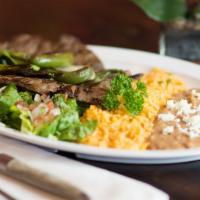 Plato De Asada · Grilled skirt steak. 
Served with rice, beans, and salad.