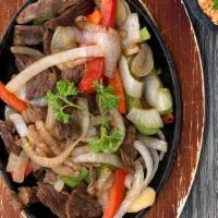 Fajitas De  Res · Steak Fajitas sautéed with mixed 
bell peppers and onions. Served with rice and beans.