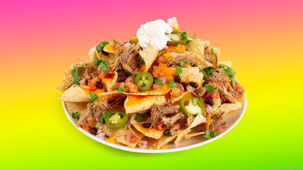 Carnitas Nachos · Melty nachos loaded with carnitas, melted cheese, pico de gallo, black beans, and your choice of additional toppings.
