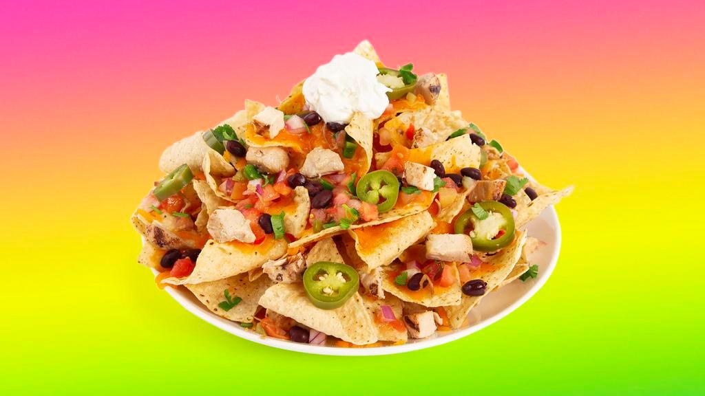 Chicken Nachos · Melty nachos loaded with chicken, melted cheese, pico de gallo, black beans, and your choice of additional toppings.