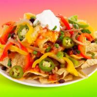 Fajita Nachos · Melty nachos loaded with fajita veggies, melted cheese, pico de gallo, black beans, and your...