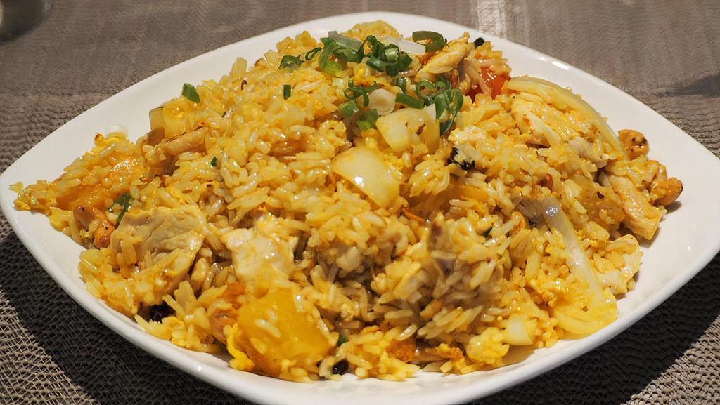 Pineapple Fried Rice · Comes with pea, carrot, white onion, and raisin sautée with eggs and steamed rice.