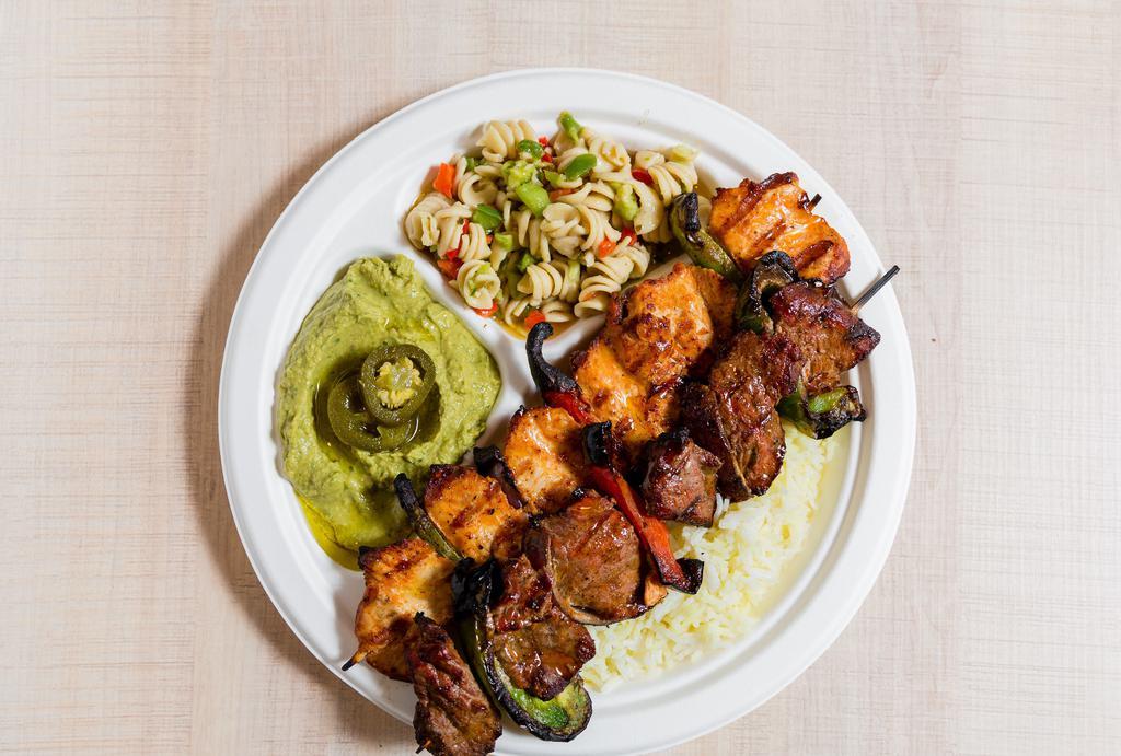 Chicken & Steak Kabob Plate · One chicken &  one steak kabob served on a bed of rice, with your choice of two sides- served with pita bread and garlic sauce.
