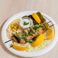 Salmon Plate · Wild caught fresh salmon- served on a bed of rice with your choice of two sides. Pita bread ...