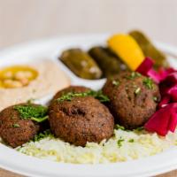 Falafel Plate · Five freshly made golden brown falafel's served on a bed of rice with your choice of two sid...