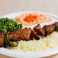 Steak Kabob Plate · Top sirloin steak- served on a bed of rice with your choice of two sides. Pita bread and gar...