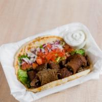 Gyro Wrap · Fresh of the spit beef & lamb- served on a fluffy pita wrap with your choice of toppings and...