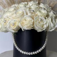 Petite Hatbox  · Designer choice flowers in a small hatbox. Hatbox color and florals subject to availability....
