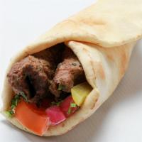 Kafta Wrap  · Ground Beef Sirloin Kebab, Hummus, Tomato, Red Onions, Parsley & Tahini Sauce Wrapped in a P...